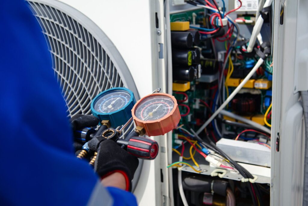 hvac technician diagnosing AC repair