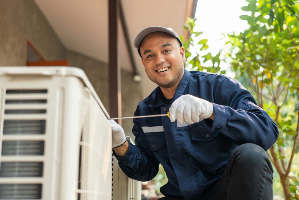 HVAC technician inspecting an outdoor air conditioner unit to assess repair or replacement