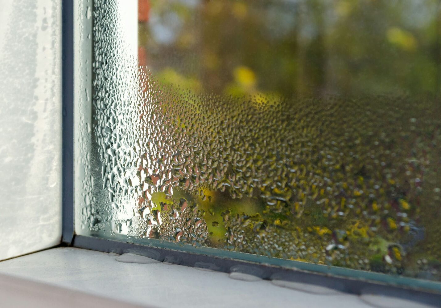 Condensation on interior windows of an Ontario home showing humidity remaining despite the AC running